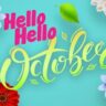 Colorful flowers and a smiling bee surround the text "Hello October in the Garden" on a bright blue background. A person in a fairy costume is on the left, adding magic to this vibrant scene.