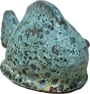 The Portica Dog Grey Decor L 19x14x23cm features a textured rock design with a weathered green-blue surface and small holes, echoing the rugged charm of nature.