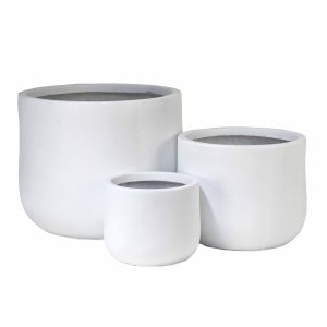 Three white, round ceramic plant pots of varying sizes are placed together on a plain background.