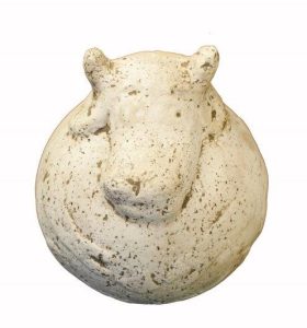 A round, speckled, white sculpture resembling the head of a hippopotamus, viewed from above against a plain background.