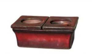 A rectangular red ceramic African Violet Dual Self-Watering Planter (18x12x7cm) with two side-by-side circular openings on top, shown against a white background.