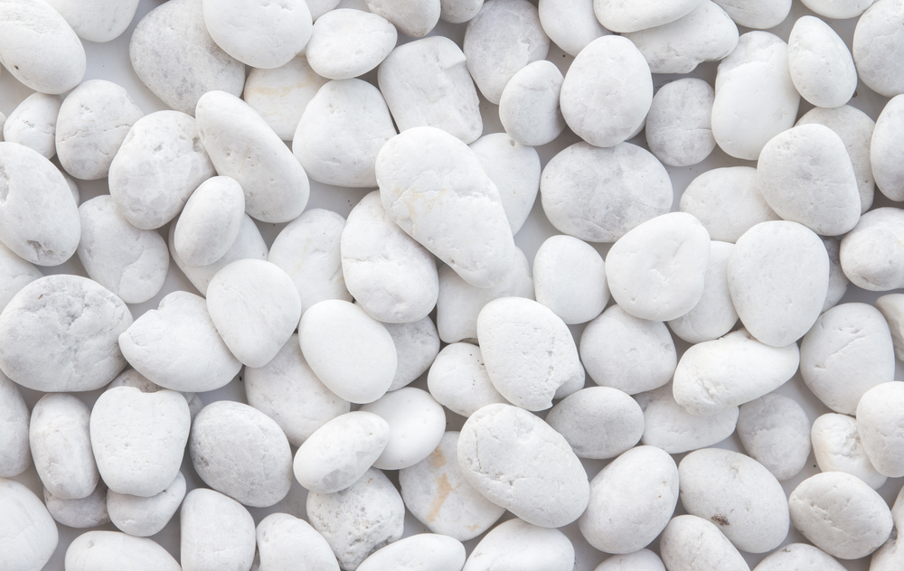 Pebbles Snow White 10-30mm 20kg Bag features smoothly polished pebbles in varying sizes, closely arranged for a refined look.
