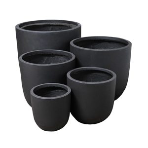 Five black round plant pots of varying sizes, featuring a sleek GardenLite Egg Planter Black XXL 62x58cm, are grouped together against a plain background.