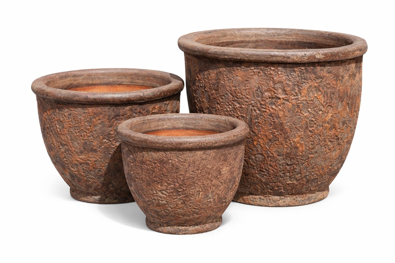 Three round, textured, brown ceramic plant pots of varying sizes are arranged side by side on a white background.