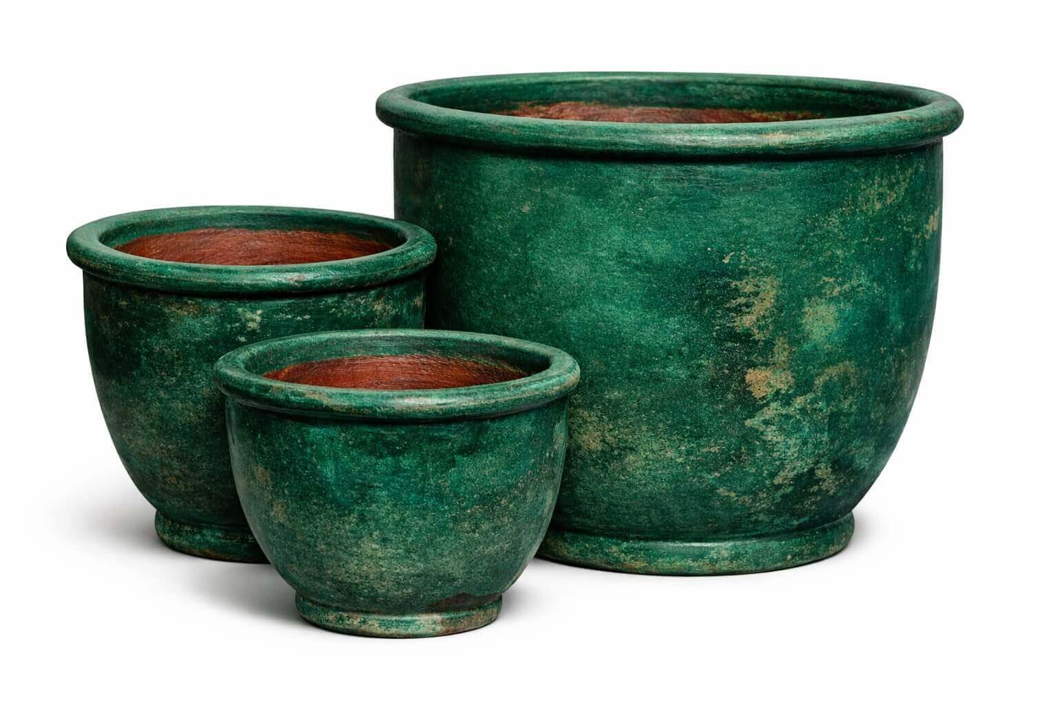 Three green ceramic flower pots of varying sizes are arranged together on a white background.