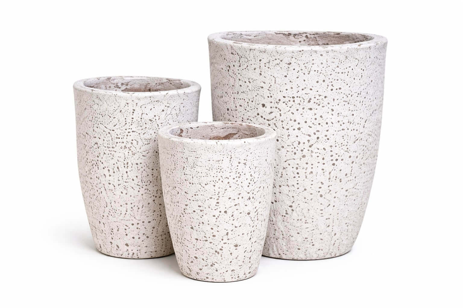 Three white, textured cylindrical planters of varying heights are arranged closely together on a white background.
