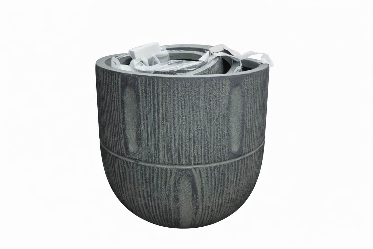 A medium, empty GardenLite Torino Tapered Planter Rust with textured sides and packaging materials inside, shown against a plain white background.