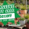 Outdoor display of various ceramic pots at the Plant Nursery, with a large sign advertising a massive pot sale—50% off all pot sets, in store only.